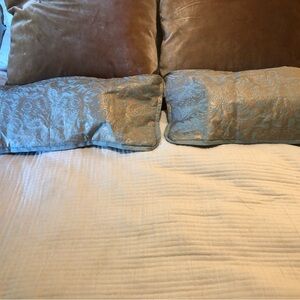 Pair of Fortuny Italian hand blocked gold on aqua oblong pillows. Size 26”x10”h